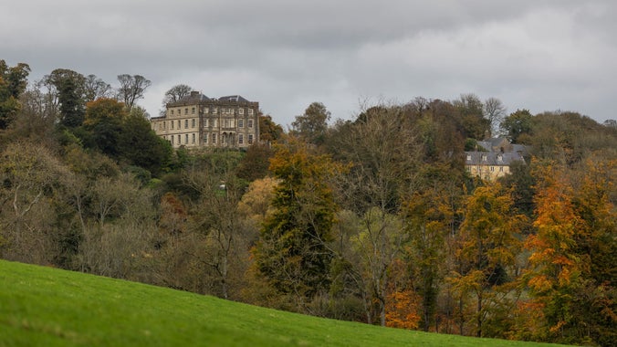 An autumn view of the house from estate walks, Newark Park, Gloucestershire